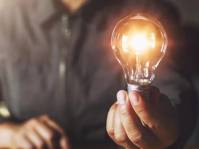 hand holding lightbulb
